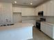 Contemporary kitchen featuring white cabinetry, stainless appliances, and tile backsplash at 9613 Vibrant Lane, Venice, FL 34292