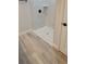 Walk-in shower with white marble tile and pebble floor design at 7137 Benson St, Englewood, FL 34224