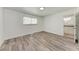 Bright bedroom featuring wood-look flooring and an ensuite bathroom at 822 Diane Cir, Englewood, FL 34223