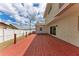 Newly built red deck with sliding glass doors leading to the house at 822 Diane Cir, Englewood, FL 34223