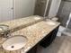 Bathroom with granite countertops and double sinks at 4916 White Sanderling Ct, Tampa, FL 33619