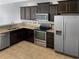 Modern kitchen features stainless steel appliances and granite countertops at 4916 White Sanderling Ct, Tampa, FL 33619