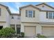 Two-story townhome with tan siding and two-car garage at 4916 White Sanderling Ct, Tampa, FL 33619