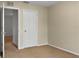 Simple bedroom with carpet, door, and access to another room at 4916 White Sanderling Ct, Tampa, FL 33619