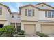 Two-story townhome with tan siding and two-car garage at 4916 White Sanderling Ct, Tampa, FL 33619