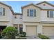Two-story townhome with tan siding and two-car garage at 4916 White Sanderling Ct, Tampa, FL 33619