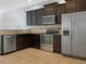 Modern kitchen with dark cabinetry and stainless steel appliances at 4916 White Sanderling Ct, Tampa, FL 33619