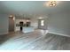 Open concept kitchen with island, stainless steel appliances, and grey vinyl flooring at 7137 Benson St, Englewood, FL 34224