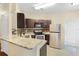 Modern kitchen with granite countertops and stainless steel appliances at 10407 Villa View Cir # 10407, Tampa, FL 33647