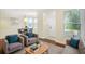 Bright living room features hardwood floors, comfy seating, and natural light at 10407 Villa View Cir # 10407, Tampa, FL 33647