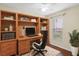 Home office with built-in shelves and hardwood floors at 10407 Villa View Cir # 10407, Tampa, FL 33647