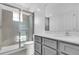 Bathroom featuring a tiled shower with glass door, modern vanity, and updated fixtures at 17314 Alderwood Ln, Punta Gorda, FL 33982