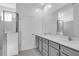 Elegant bathroom featuring double sinks, a large mirror, modern vanity, and a glass-enclosed shower at 17314 Alderwood Ln, Punta Gorda, FL 33982