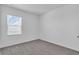 Neutral bedroom with a window and plush carpeting offers a serene and comfortable space at 17314 Alderwood Ln, Punta Gorda, FL 33982