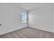 A cozy bedroom with neutral carpet and ample natural light from a window with blinds at 17314 Alderwood Ln, Punta Gorda, FL 33982