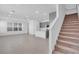 Open living area with a modern kitchen, staircase, recessed lighting, and large windows for natural light at 17314 Alderwood Ln, Punta Gorda, FL 33982