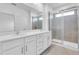 Bathroom featuring a double sink vanity and glass enclosed shower at 17326 Alderwood Ln, Punta Gorda, FL 33982