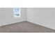 Bright bedroom with plush carpet and a window allowing ample natural light at 17326 Alderwood Ln, Punta Gorda, FL 33982