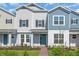 Charming two-story townhome with blue front door and manicured landscaping at 17326 Alderwood Ln, Punta Gorda, FL 33982