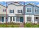 Charming two-story townhome with blue front door and manicured landscaping at 17326 Alderwood Ln, Punta Gorda, FL 33982
