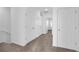Hallway featuring carpet, multiple closets and white doors at 17326 Alderwood Ln, Punta Gorda, FL 33982