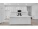 The kitchen features white cabinets, stainless steel appliances, and center island at 17326 Alderwood Ln, Punta Gorda, FL 33982