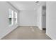 Bright living room with large windows and tile flooring, offering a clean and modern space at 17326 Alderwood Ln, Punta Gorda, FL 33982