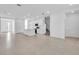 Spacious living room with modern tile flooring and open floor plan at 17326 Alderwood Ln, Punta Gorda, FL 33982