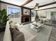 Living room with a fireplace, hardwood floors, and large windows at 1427 E Gate Dr, Venice, FL 34285