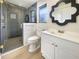 Modern bathroom with white vanity, walk-in shower, and stylish mirror at 1427 E Gate Dr, Venice, FL 34285