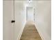 Bright hallway with light wood-look flooring and crisp white walls at 1427 E Gate Dr, Venice, FL 34285