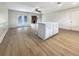 White kitchen island with light countertops and hardwood floors at 1427 E Gate Dr, Venice, FL 34285