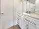 Modern bathroom vanity with white cabinets and quartz countertop at 1427 E Gate Dr, Venice, FL 34285