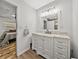 Bathroom with white vanity, marble countertop, and a view of bedroom at 11805 Carmen Ave, Dade City, FL 33525