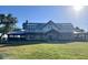 Two-story farmhouse style home with metal roof and large front yard at 17351 Peregrine Way, Punta Gorda, FL 33982