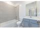 Clean bathroom with gray vanity, white toilet, and bathtub at 17347 Peregrine Way, Punta Gorda, FL 33982