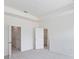 Empty bedroom with neutral walls, carpet flooring, and multiple closets at 17347 Peregrine Way, Punta Gorda, FL 33982