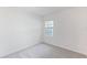 Well-lit bedroom with gray carpeting and a window offering natural light at 17347 Peregrine Way, Punta Gorda, FL 33982