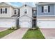Three-unit townhome building with attached garages and landscaping at 17347 Peregrine Way, Punta Gorda, FL 33982