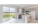 Modern kitchen island and view of backyard from sliding glass door at 17347 Peregrine Way, Punta Gorda, FL 33982