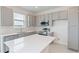 Modern kitchen with gray cabinets, quartz countertops, and stainless steel appliances at 17347 Peregrine Way, Punta Gorda, FL 33982