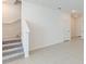 Modern carpeted staircase with white railings and access to upper floor at 17347 Peregrine Way, Punta Gorda, FL 33982