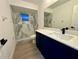 Modern bathroom with blue vanity and marble shower at 4469 Cunningham St, Port Charlotte, FL 33948