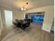Dining area with a dark brown table, six chairs, and access to the backyard at 4469 Cunningham St, Port Charlotte, FL 33948