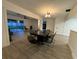 Open concept dining room with dark table and chairs at 4469 Cunningham St, Port Charlotte, FL 33948