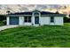 House exterior featuring a gray garage door and lush green lawn at 4469 Cunningham St, Port Charlotte, FL 33948