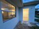 Inviting house exterior featuring a well-lit entryway and a glimpse of the interior at 4469 Cunningham St, Port Charlotte, FL 33948