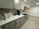 Modern kitchen with gray cabinets, quartz countertops, and stainless steel sink at 4469 Cunningham St, Port Charlotte, FL 33948