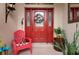 Red front door with a wreath and a red chair on the porch at 6043 Anvil Ave, Sarasota, FL 34243