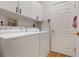 Convenient laundry room with washer, dryer and storage cabinets at 6043 Anvil Ave, Sarasota, FL 34243